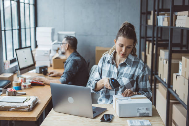 two business partners working together at warehouse for online seller business.